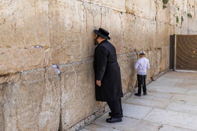An Ultra-Orthodox man prays at the Western Wall in the old city of Jerusalem on April 19, 2026. (Photo by ilia YEFIMOVICH / AFP)