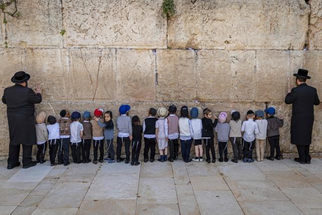 Ultra-Orthodox children visit the Western Wall in the old city of Jerusalem on April 19, 2026. (Photo by ilia YEFIMOVICH / AFP)