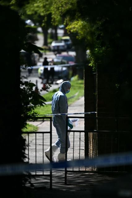 A police forensic officer works inside a cordon set up near to Kenton United Synagogue in Harrow, north-west London on April 19, 2026, the scene of an arson attack overnight. (Photo by JUSTIN TALLIS / AFP)