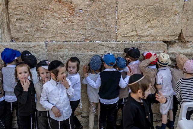 Ultra-Orthodox children visit the Western Wall in the old city of Jerusalem on April 19, 2026. (Photo by ilia YEFIMOVICH / AFP)