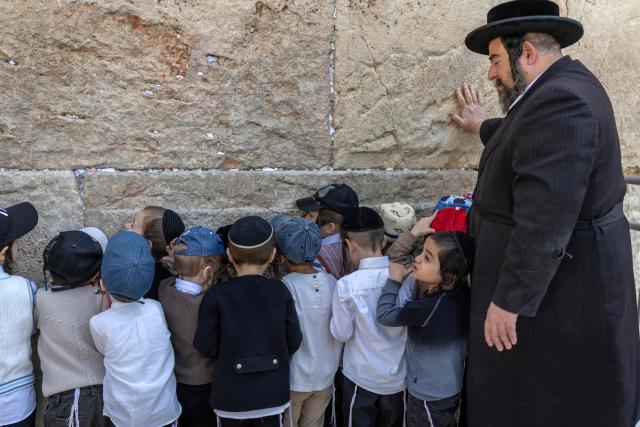 Ultra-Orthodox children visit the Western Wall in the old city of Jerusalem on April 19, 2026. (Photo by ilia YEFIMOVICH / AFP)