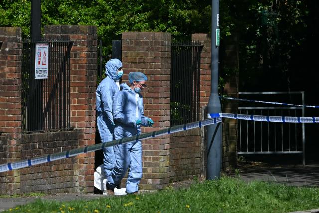 Police forensic officers work inside a cordon set up near to Kenton United Synagogue in Harrow, north-west London on April 19, 2026, the scene of an arson attack overnight. (Photo by JUSTIN TALLIS / AFP)