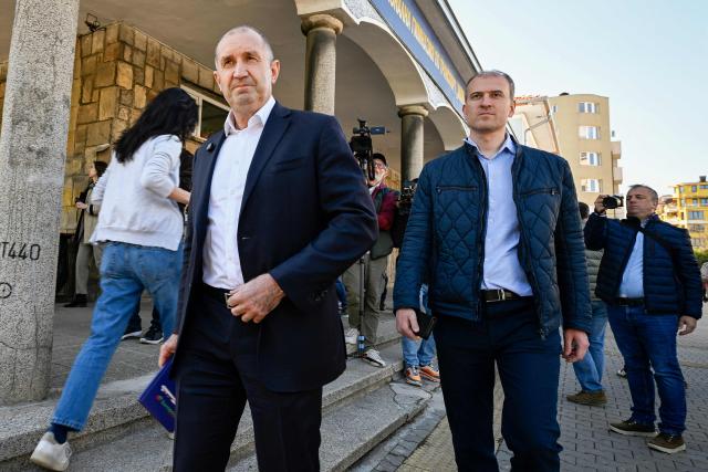 Progressive Bulgaria coalition's leader and former President Radev Rumen (L) leaves the polling station after casting his ballot during Bulgaria's parliamentary elections in Sofia on April 19, 2026. Bulgarians vote in the country's eighth election in five years today, with ex-president Rumen Radev's grouping tipped to win on a pledge to fight corruption, after an anti-graft movement triggered a long political crisis. (Photo by Dimitar KYOSEMARLIEV / AFP)