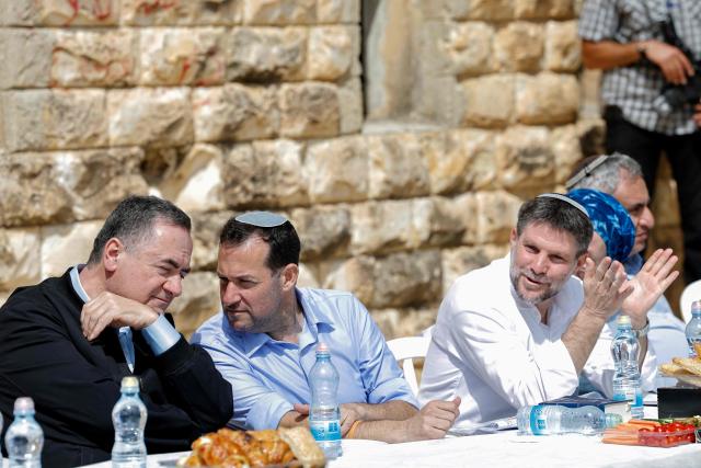 Israeli Defence Minister Israel Katz, (L), Yossi Dagan, Head of the Shomron Regional Council (C-L), and srael's far-right Finance Minister Bezalel Smotrich (C-R) attend the resettlement ceremony of Sa-Nur, south of Jenin, in the Israeli-occupied West Bank on April 19, 2026. Smotrich announced on August 7 plans to rebuild Sa-Nur, a settlement in the occupied West Bank that was evacuated two decades ago, as the far right spearheads a major settlement expansion push. Sa-Nur's settlers were evicted in 2005 as part of Israel's so-called disengagement policy that also saw the country withdrawing troops and settlers from the Gaza Strip. (Photo by Marco Longari / AFP)