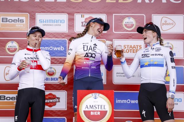 (From L) Second-placed Canyon - SRAM Zondacrypto team's Polish rider Kasia Niewiadoma-Phinney, winner UAE Team ADQ's Spanish rider Paula Blasi and third placed FDJ United - Suez team's Dutch rider Demi Vollering celebrate on the podium after winning the women's 2026 Amstel Gold Race in Valkenburg on April 19, 2026. (Photo by Marcel VAN HOORN / ANP / AFP) / Netherlands OUT
