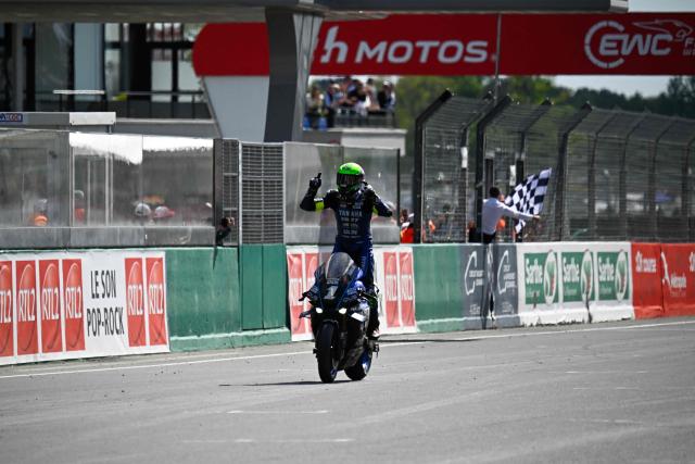 Yart Yamaha Official team's German formula EWC rider #1 Marvin Fritz celebrates as he crosses the finish line to win the 49th Le Mans 24-hours endurance moto race, in Le Mans, northwestern France, on April 19, 2026. (Photo by JULIEN DE ROSA / AFP)