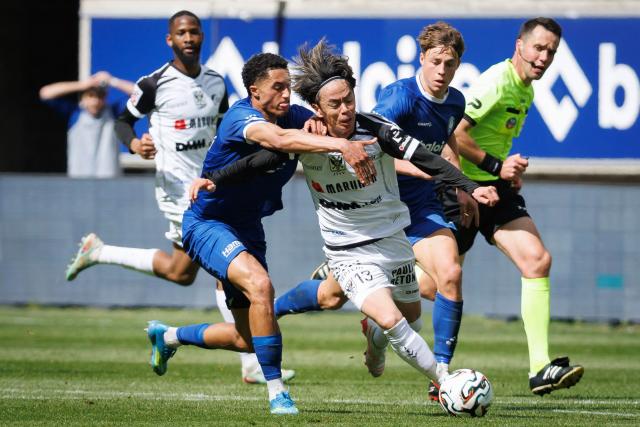 STVV's Japanese midfielder #13 Ryotaro Ito (C) and KAA Gent's Dutch midfielder #10 Aime Omgba fight for the ball during the Belgian "Pro League" First Division football match of the third day of the Champion's Play-offs between KAA Gent and Sint-Truidense VV (STVV) at the KAA Stadium in Ghent on April 19, 2026. (Photo by KURT DESPLENTER / BELGA / AFP) / Belgium OUT