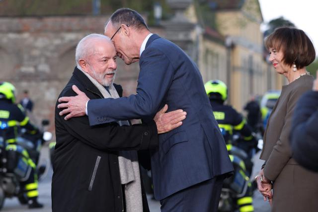 German Chancellor Friedrich Merz and his wife Charlotte Merz welcome Brazilian President Luiz Inacio Lula da Silvam at his arrival at the Herrenhausen Palace in Hannover on April 19, 2026, ahead of their visit to the Hannover industrial trade fair. The fair opens its doors to the public on April 20 and will be running until April 24, 2024. (Photo by Ronny HARTMANN / AFP)