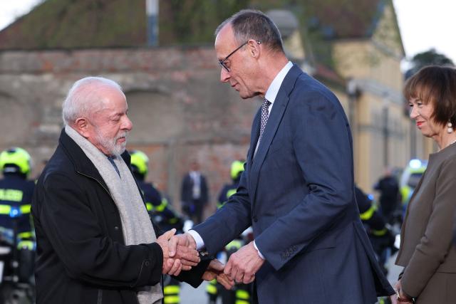 German Chancellor Friedrich Merz and his wife Charlotte Merz welcome Brazilian President Luiz Inacio Lula da Silvam at his arrival at the Herrenhausen Palace in Hannover on April 19, 2026, ahead of their visit to the Hannover industrial trade fair. The fair opens its doors to the public on April 20 and will be running until April 24, 2024. (Photo by Ronny HARTMANN / AFP)
