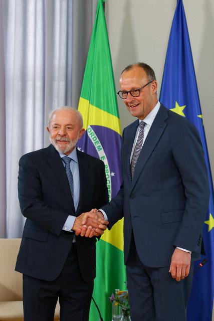 German Chancellor Friedrich Merz (R) shakes hands with Brazilian President Luiz Inacio Lula da Silva, as they meet for bilateral talks, in Hanover, Germany, April 19, 2026. (Photo by Lisi Niesner / POOL / AFP)