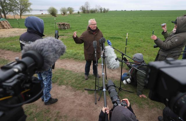 Till Backhaus, environment minister for the state of Mecklenburg-Western Pomerania delivers a press statement on rescue efforts to save a humpback whale at the Baltic Sea coast near the island of Poel, near Wismar, northern Germany, on April 19, 2026. A private rescue attempt for the whale still goes on. The 13.5-metre (44-foot) humpback whale's ordeal first began in late March 2026 when it was spotted stuck on a sandbank near the city of Luebeck. It first freed itself only to become stuck again further east along the German coast. Earlier in April 2026 officials said they expected the animal to die, saying it had been too weakened by the odyssey to survive and make its way back to its natural habitat in the Atlantic. Coverage of the whale's struggle for survival and efforts to rescue it have gripped the German public, with some of the press calling the animal "Timmy". (Photo by Danny Gohlke / AFP)