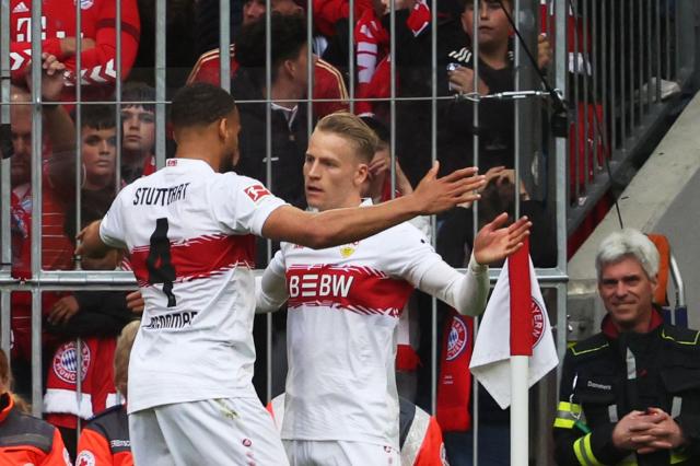 Stuttgart's German midfielder #10 Chris Fuehrich (R) celebrates with Stuttgart's German defender #04 Josha Vagnoman (L) after scoring the opening 0-1 goal during the German first division Bundesliga football match between FC Bayern Munich and VfB Stuttgart in Munich, southern Germany, on April 19, 2026. (Photo by Karl-Josef HILDENBRAND / AFP) / DFL REGULATIONS PROHIBIT ANY USE OF PHOTOGRAPHS AS IMAGE SEQUENCES AND/OR QUASI-VIDEO
