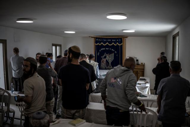 Israeli settlers gather to pray in a synagogue at the end of the resettlement ceremony of Sa-Nur, south of Jenin in the Israeli-occupied West Bank, on April 19, 2026. Israeli ministers on April 19 officially reopened Sa-Nur, a settlement in the occupied West Bank that was evacuated 20 years ago, marking the occasion with defiant declarations against Palestinian statehood and calls to resettle Gaza. (Photo by MARCO LONGARI / AFP)