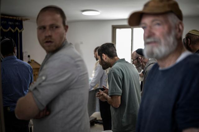 Israeli settlers gather to pray in a synagogue at the end of the resettlement ceremony of Sa-Nur, south of Jenin in the Israeli-occupied West Bank, on April 19, 2026. Israeli ministers on April 19 officially reopened Sa-Nur, a settlement in the occupied West Bank that was evacuated 20 years ago, marking the occasion with defiant declarations against Palestinian statehood and calls to resettle Gaza. (Photo by MARCO LONGARI / AFP)