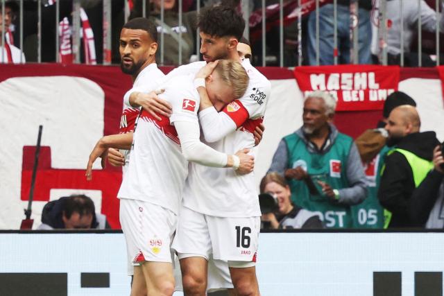 Stuttgart's German midfielder #10 Chris Fuehrich (2nd R) celebrates with Stuttgart's German midfielder #16 Atakan Karazor (R) after scoring the opening 0-1 goal during the German first division Bundesliga football match between FC Bayern Munich and VfB Stuttgart in Munich, southern Germany, on April 19, 2026. (Photo by Karl-Josef HILDENBRAND / AFP) / DFL REGULATIONS PROHIBIT ANY USE OF PHOTOGRAPHS AS IMAGE SEQUENCES AND/OR QUASI-VIDEO