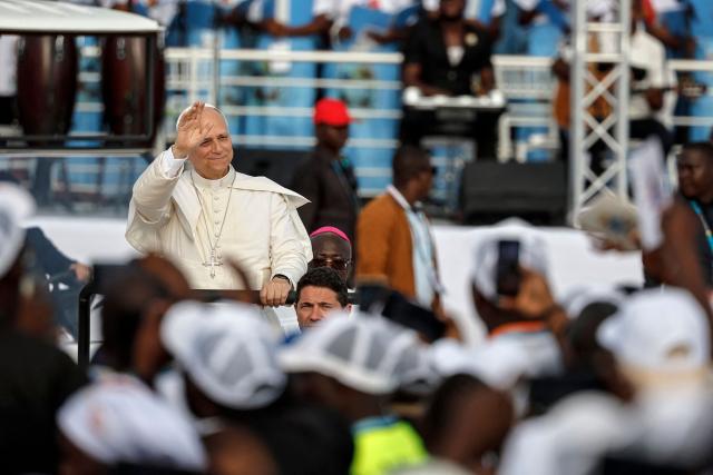 Pope Leo XIV waves to the crowd as he arrives to lead a Holy Rosary Prayer on the esplanade in front of the "Mama Muxima" Shrine in Muxima on the seventh day of an 11-day apostolic journey to Africa, on April 19, 2026. (Photo by PHILL MAGAKOE / AFP)