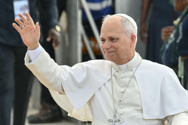 Pope Leo XIV waves to the crowd as he arrives to lead a Holy Rosary Prayer on the esplanade in front of the "Mama Muxima" Shrine in Muxima on the seventh day of an 11-day apostolic journey to Africa, on April 19, 2026. (Photo by Alberto PIZZOLI / AFP)