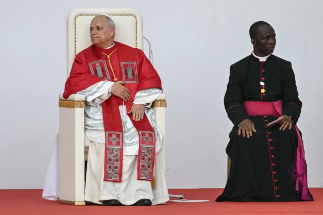 Pope Leo XIV (L) attends a Holy Rosary Prayer on the esplanade in front of the "Mama Muxima" Shrine in Muxima on the seventh day of an 11-day apostolic journey to Africa, on April 19, 2026. (Photo by Alberto PIZZOLI / AFP)
