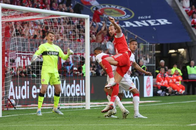 Bayern Munich's English forward #09 Harry Kane (2nd R) eyes the ball in front of the goal during the German first division Bundesliga football match between FC Bayern Munich and VfB Stuttgart in Munich, southern Germany, on April 19, 2026. (Photo by Karl-Josef HILDENBRAND / AFP) / DFL REGULATIONS PROHIBIT ANY USE OF PHOTOGRAPHS AS IMAGE SEQUENCES AND/OR QUASI-VIDEO
