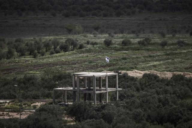 An Israeli flag flutters atop an unfinished structure built on the outskirts of the Palestinian village of Turmus Ayya village, north of Ramallah in the Israeli-occupied West Bank, on April 19, 2026. Violence in the West Bank, which Israel has occupied since 1967, has risen sharply since the October 7, 2023 Hamas attack on Israel triggered the Gaza war. There has also been a spike in deadly attacks by Israeli settlers in the occupied West Bank since the start of the Iran war on February 28, Palestinian authorities and the United Nations have said. (Photo by MARCO LONGARI / AFP)