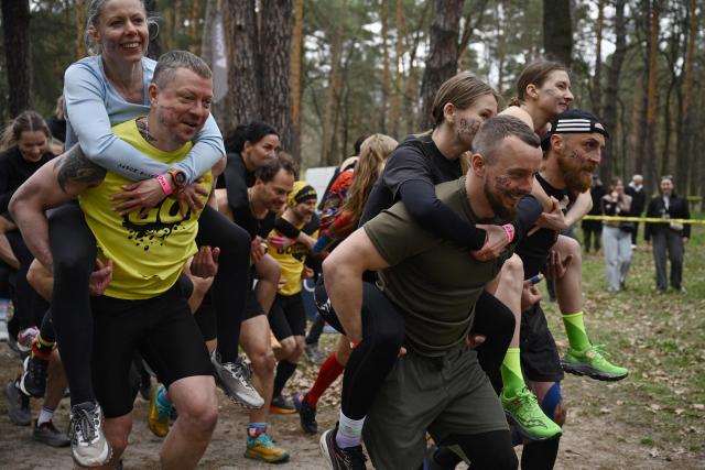 Ukrainian servicemen participate in the Dyka Gonka (Wild Race) competition run in Kyiv on April 19, 2026, amid the Russian invasion of Ukraine. The Dyka Gonka (Wild Race), in which military personnel, veterans and civilians participate, combines various types of activities - running across rough terrain, overcoming obstacles, and battling the challenges of nature on distances of 300 meters, 1.6 km, and 5 km. (Photo by Genya SAVILOV / AFP)