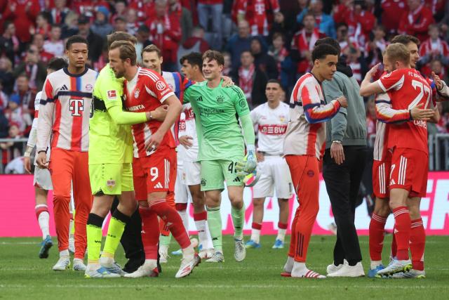 Bayern Munich's English forward #09 Harry Kane (3rd L) celebrates with team mates after winning the German first division Bundesliga football match between FC Bayern Munich and VfB Stuttgart in Munich, southern Germany, on April 19, 2026. (Photo by Karl-Josef HILDENBRAND / AFP) / DFL REGULATIONS PROHIBIT ANY USE OF PHOTOGRAPHS AS IMAGE SEQUENCES AND/OR QUASI-VIDEO