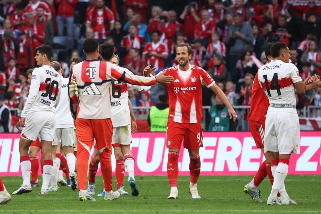 Bayern Munich's English forward #09 Harry Kane (C) celebrates with team mates after winning the German first division Bundesliga football match between FC Bayern Munich and VfB Stuttgart in Munich, southern Germany, on April 19, 2026. (Photo by Karl-Josef HILDENBRAND / AFP) / DFL REGULATIONS PROHIBIT ANY USE OF PHOTOGRAPHS AS IMAGE SEQUENCES AND/OR QUASI-VIDEO