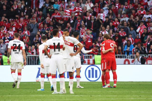 Bayern Munich's English forward #09 Harry Kane (R) celebrates with team mates after winning the German first division Bundesliga football match between FC Bayern Munich and VfB Stuttgart in Munich, southern Germany, on April 19, 2026. (Photo by Karl-Josef HILDENBRAND / AFP) / DFL REGULATIONS PROHIBIT ANY USE OF PHOTOGRAPHS AS IMAGE SEQUENCES AND/OR QUASI-VIDEO