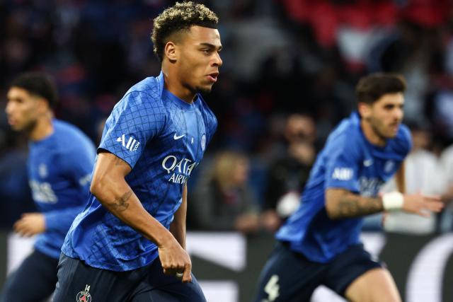 Paris Saint-Germain's French midfielder #14 Desire Doue warms up prior to the French L1 football match between Paris Saint-Germain (PSG) and Olympique Lyonnais (OL) at the Parc des Princes stadium in Paris on April 19, 2026. (Photo by FRANCK FIFE / AFP)