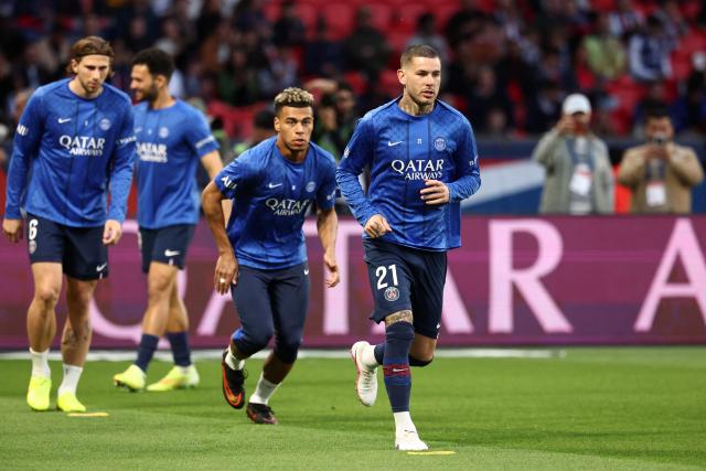 (From L) Paris Saint-Germain's Ukrainian defender #06 Illia Zabarnyi, Paris Saint-Germain's French midfielder #14 Desire Doue and Paris Saint-Germain's French defender #21 Lucas Hernandez warm up prior to the French L1 football match between Paris Saint-Germain (PSG) and Olympique Lyonnais (OL) at the Parc des Princes stadium in Paris on April 19, 2026. (Photo by FRANCK FIFE / AFP)