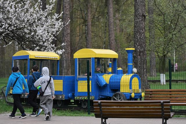 A child rides a miniature train in Kyiv on April 19, 2026, amid the Russian invasion of Ukraine. (Photo by Genya SAVILOV / AFP)