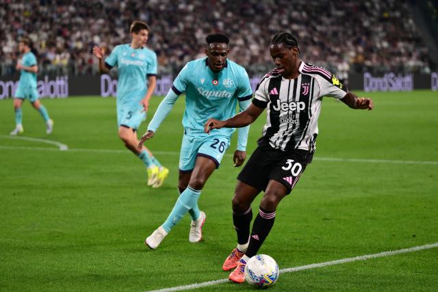Juventus' Canadian forward #30 Jonathan David fights for the ball with Bologna's Colombian defender #26 Jhon Lucumi during the Italian Serie A football match between Juventus and Bologna at the Allianz stadium in Turin, on April 19, 2026. (Photo by Marco BERTORELLO / AFP)