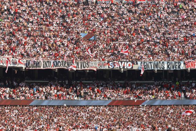 River Plate fans cheer for their team ahead of the Argentine Professional Football League 2026 Apertura Tournament match between River Plate and Boca Juniors at MAS Monumental stadium in Buenos Aires on April 19, 2026. (Photo by Alejandro PAGNI / AFP)