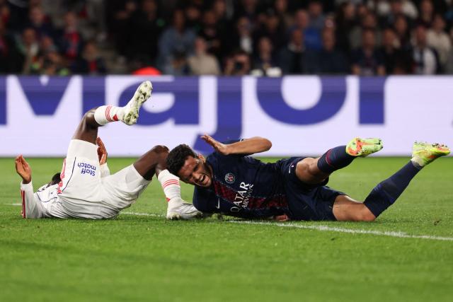 Paris Saint-Germain's Portuguese forward #09 Goncalo Ramos (R) reacts as he falls next to Lyon's Angolan defender #22 Clinton Mata (L) during the French L1 football match between Paris Saint-Germain (PSG) and Olympique Lyonnais (OL) at the Parc des Princes stadium in Paris on April 19, 2026. (Photo by FRANCK FIFE / AFP)