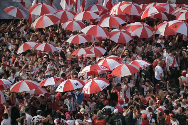 River Plate fans cheer for their team ahead of the Argentine Professional Football League 2026 Apertura Tournament match between River Plate and Boca Juniors at MAS Monumental stadium in Buenos Aires on April 19, 2026. (Photo by JUAN MABROMATA / AFP)