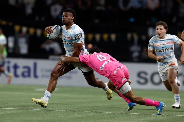 Racing 92' Fijian winger Wame Naituvi fights for the ball with Stade Français' French wing Mathis Ibo during the French Top14 rugby union match between Racing 92 and Stade Francais at the Paris La Defense Arena in Nanterre, on the outskirts of Paris on April 19, 2026. (Photo by Kenzo TRIBOUILLARD / AFP)