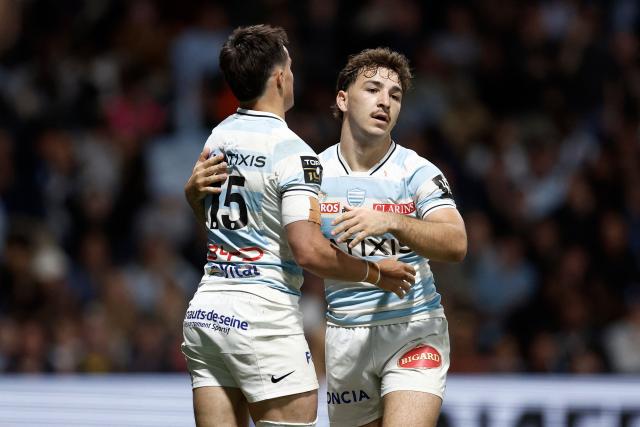 Racing 92' French full-back Max Spring celebrates with Racing 92' French scrum-half Leo Carbonneau after scoring a try during the French Top14 rugby union match between Racing 92 and Stade Francais at the Paris La Defense Arena in Nanterre, on the outskirts of Paris on April 19, 2026. (Photo by Kenzo TRIBOUILLARD / AFP)