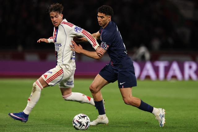 Lyon's Portuguese forward #17 Afonso Moreira (L) fights for the ball with Morocco's defender #02 Achraf Hakimi (R) during the French L1 football match between Paris Saint-Germain (PSG) and Olympique Lyonnais (OL) at the Parc des Princes stadium in Paris on April 19, 2026. (Photo by FRANCK FIFE / AFP)