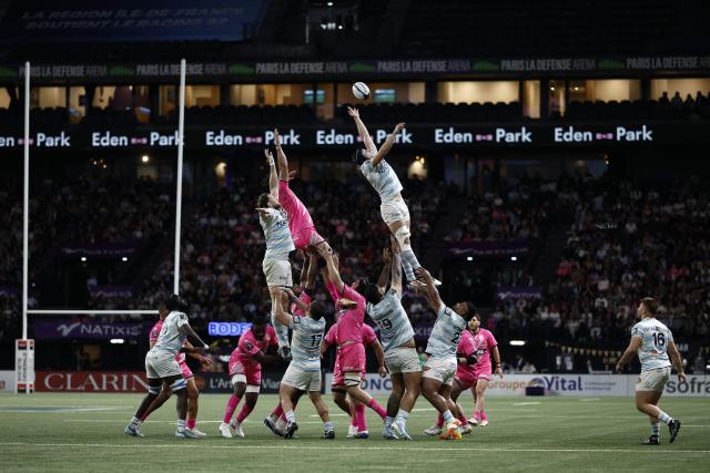 Racing 92' French flanker Maxime Baudonne (top R) jumps to grab the ball in a line-out during the French Top14 rugby union match between Racing 92 and Stade Francais at the Paris La Defense Arena in Nanterre, on the outskirts of Paris, on April 19, 2026. (Photo by Kenzo TRIBOUILLARD / AFP)