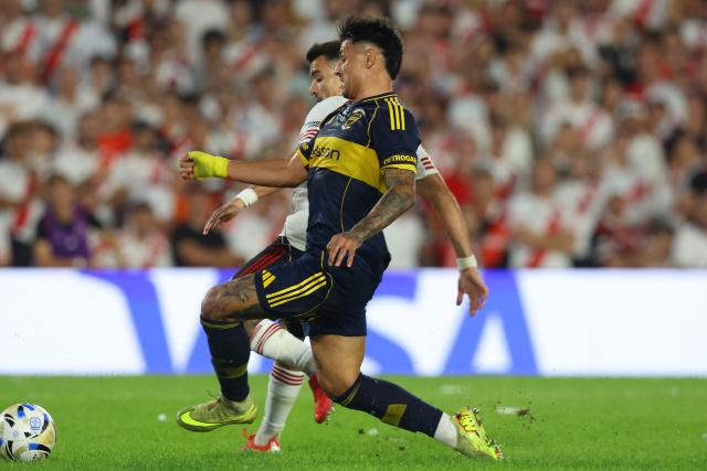 Boca Juniors' Paraguayan forward #28 Adam Bareiro (in front) and River Plate's defender #21 Marcos Acuna (behind) fight for the ball during the Argentine Professional Football League 2026 Apertura Tournament match between River Plate and Boca Juniors at MAS Monumental stadium in Buenos Aires on April 19, 2026. (Photo by Alejandro PAGNI / AFP)