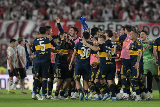 Boca Juniors' players celebrate after winning the Argentine Professional Football League 2026 Apertura Tournament match between River Plate and Boca Juniors at MAS Monumental stadium in Buenos Aires on April 19, 2026. (Photo by JUAN MABROMATA / AFP)