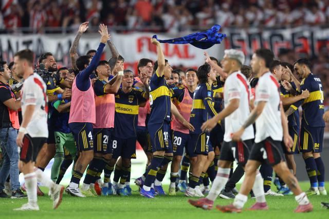 Boca Juniors' players celebrate after winning the Argentine Professional Football League 2026 Apertura Tournament match between River Plate and Boca Juniors at MAS Monumental stadium in Buenos Aires on April 19, 2026. (Photo by Alejandro PAGNI / AFP)