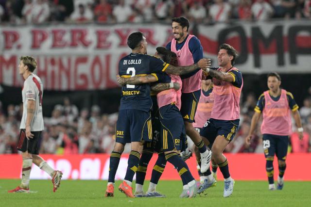 Boca Juniors' players celebrate after winning the Argentine Professional Football League 2026 Apertura Tournament match between River Plate and Boca Juniors at MAS Monumental stadium in Buenos Aires on April 19, 2026. (Photo by JUAN MABROMATA / AFP)