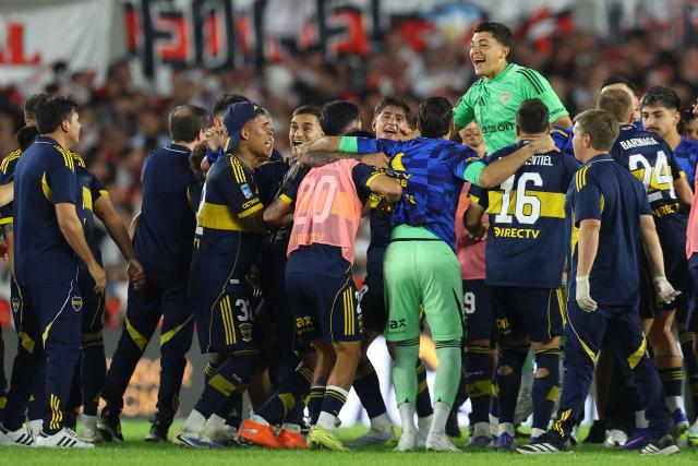 Boca Juniors' players celebrate after winning the Argentine Professional Football League 2026 Apertura Tournament match between River Plate and Boca Juniors at MAS Monumental stadium in Buenos Aires on April 19, 2026. (Photo by Alejandro PAGNI / AFP)