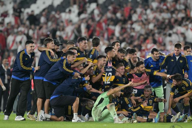 Boca Juniors' players celebrate after winning the Argentine Professional Football League 2026 Apertura Tournament match between River Plate and Boca Juniors at MAS Monumental stadium in Buenos Aires on April 19, 2026. (Photo by JUAN MABROMATA / AFP)