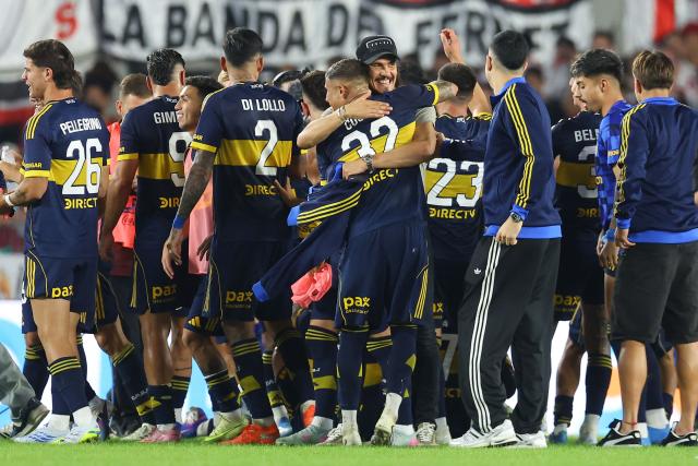 Boca Juniors' players celebrate after winning the Argentine Professional Football League 2026 Apertura Tournament match between River Plate and Boca Juniors at MAS Monumental stadium in Buenos Aires on April 19, 2026. (Photo by Alejandro PAGNI / AFP)