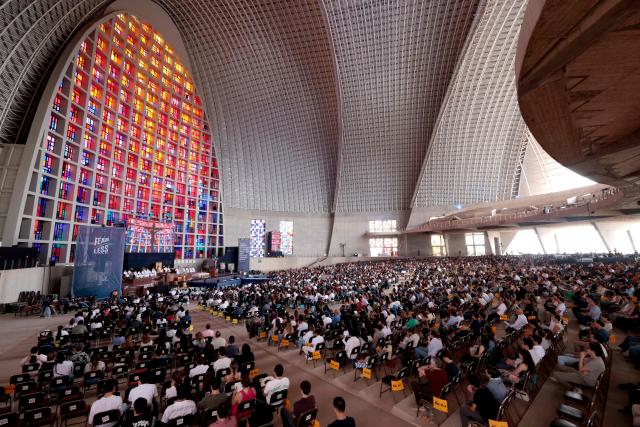 People attend a mass during the 2026 Fearless Congress at the Sanctuary of the Mexican Martyrs in Tlaquepaque, Jalisco state, Mexico on April 19, 2026. The Fearless Congress is hosted by conservative Catholics from Regnum Christi, a lay movement of the Legionaries of Christ, in response to the "attack on masculinity" that is growing in Mexico amid the rise of feminism, according to the event's organizers on their website. On April 16, 2026, feminist organizations protested against the event in front of the Ministry of the Interior, arguing that it spreads "hate speech" and highlighting the severe gender-based violence in Mexico. (Photo by Ulises RUIZ / AFP)