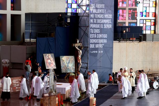 Priests celebrate a mass during the 2026 Fearless Congress at the Sanctuary of the Mexican Martyrs in Tlaquepaque, Jalisco state, Mexico on April 19, 2026. The Fearless Congress is hosted by conservative Catholics from Regnum Christi, a lay movement of the Legionaries of Christ, in response to the "attack on masculinity" that is growing in Mexico amid the rise of feminism, according to the event's organizers on their website. On April 16, 2026, feminist organizations protested against the event in front of the Ministry of the Interior, arguing that it spreads "hate speech" and highlighting the severe gender-based violence in Mexico. (Photo by Ulises RUIZ / AFP)