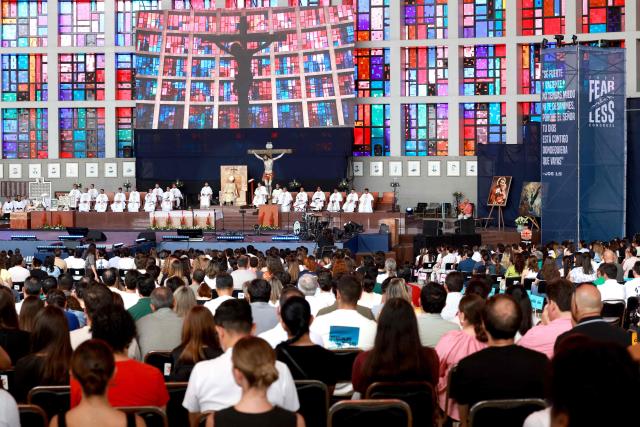 People attend a mass during the 2026 Fearless Congress at the Sanctuary of the Mexican Martyrs in Tlaquepaque, Jalisco state, Mexico on April 19, 2026. The Fearless Congress is hosted by conservative Catholics from Regnum Christi, a lay movement of the Legionaries of Christ, in response to the "attack on masculinity" that is growing in Mexico amid the rise of feminism, according to the event's organizers on their website. On April 16, 2026, feminist organizations protested against the event in front of the Ministry of the Interior, arguing that it spreads "hate speech" and highlighting the severe gender-based violence in Mexico. (Photo by Ulises RUIZ / AFP)