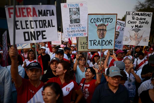Supporters of ultra-conservative candidate Rafael Lopez Aliaga take part in a protest over alleged fraud following the results of the presidential election in Lima on April 19, 2026. (Photo by ERNESTO BENAVIDES / AFP)